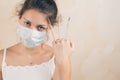 A sickly-looking girl holds 3 mercury thermometers in her fist Royalty Free Stock Photo