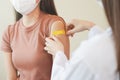 Sickness asian young woman nurse ,doctor giving syringe vaccine, inject shot to arm's patient. Vaccination, immunizatio Royalty Free Stock Photo