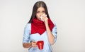 Sickness woman holding red cup blow up nose in paper tissue. Royalty Free Stock Photo