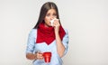 Sickness woman holding red cup blow up nose in paper tissue. Royalty Free Stock Photo