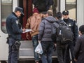 Croatian police officers checking refugees, boarding a train to cross the Croatia Serbia border, at the Sid train station