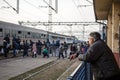 Old man looking at a group of refugees boarding a train to cross the Croatia Serbia border Royalty Free Stock Photo