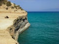 Sidari, Corfu, Greece - rocky cliff with backpacks and beautiful turquoise water