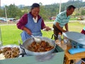 Woman cooks typical food at local open market. Ecuador