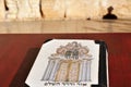 Siddur book against the Western Wailing Kotel Wall in Jerusalem old city Israel