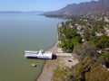 Side Aerial view of Ajijic boardwalk, lake and some trees