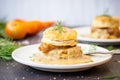 side angle of biscuit halves smothered in thick, peppery gravy