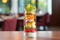 side angle, layered beet salad in tall glass, fine dining style
