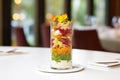 side angle, layered beet salad in tall glass, fine dining style