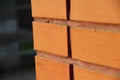 Side angle of an orange brick wall. Perspective view of modern brickwork in loft style Royalty Free Stock Photo