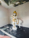Side angle potrait photo of beautiful white statue of lord Krishna in the temple of konkan. Royalty Free Stock Photo