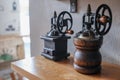 Side angle view of vintage hand manual coffee grinder on wooden