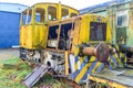 Side angle view of yellow dismantled and dilapidated old train control cabin Royalty Free Stock Photo
