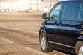 Side back view of black VIP service van running on airport taxiway with terminal building on background. Business class Royalty Free Stock Photo