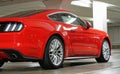 side back view of red sport ford mustang gt, underground car park with white shiny lights Royalty Free Stock Photo