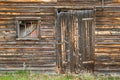 Distressed Barn Siding Door With Cluttered Window.