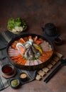 Side of beef garnished with sesame, and shellfish with prawns arranged on the tray combined with vegetables for grill set on the Royalty Free Stock Photo