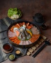 Side of beef garnished with sesame, and shellfish with prawns arranged on the tray combined with vegetables for grill set on the Royalty Free Stock Photo