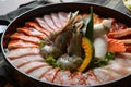 Side of beef garnished with sesame, and shellfish with prawns arranged on the tray combined with vegetables for grill set on the Royalty Free Stock Photo