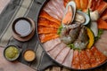 Side of beef garnished with sesame, and shellfish with prawns arranged on the tray combined with vegetables for grill set on the Royalty Free Stock Photo