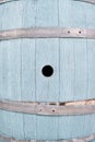 Side of a blue wooden barrel with a round hole Royalty Free Stock Photo