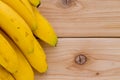 Side border of a bunch of ripe yellow bananas