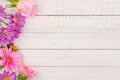 Side border of pink and purple flowers against white wood Royalty Free Stock Photo