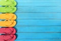 Side border row of flip-flops on blue background wood beach deck Royalty Free Stock Photo