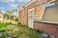 the side of a brick house with a large window Royalty Free Stock Photo