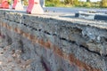 Side of the broken asphalt road collapsed and fallen. Road collapses. Layer of soil beneath section. Cracked asphalt road. constru