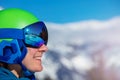 Side close-up portrait of a smiling woman in ski helmet Royalty Free Stock Photo