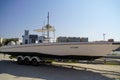 Side and close up view of a white speedboat is parked on a cart by the beach. : Dubai UAE - July 2019