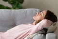 Side close up view woman having day nap on couch Royalty Free Stock Photo