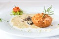 Side closeup of potato cutlets with mushroom sauce on a white plate and background Royalty Free Stock Photo