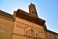 Side door on Calle San Blas and tower of the church of San Pablo in the neighborhood of el Gancho in Saragossa, Spain