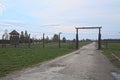 Side entrance of the concentration camp and dry rose. Royalty Free Stock Photo