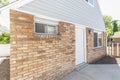 Side exterior of a small guest house with wall lamp, bricks and windows Royalty Free Stock Photo