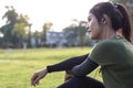 Side face of a young woman sitting in a park. Royalty Free Stock Photo