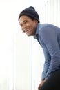 Side of handsome young african american man smiling with beanie