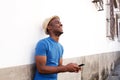 Side of happy african american man holding cellphone Royalty Free Stock Photo