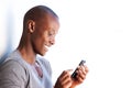 Side of happy young black man using cellphone Royalty Free Stock Photo