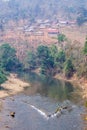 Side hill village alongside river rural of Laos, along the road