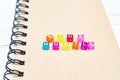 Side Hustle words made form multicolored square beads on spiral notebook cover. Concept image of passive income Royalty Free Stock Photo