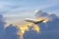 Side image commercial passenger aircraft or cargo transportation airplane flying through over fluffy cloudy with blue sky and Royalty Free Stock Photo