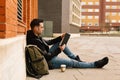 Side image of a handsome young boy and student, reading a book outdoors and copy space Royalty Free Stock Photo