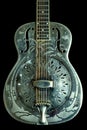 Side Lighting: Vintage Resonator Acoustic Guitar Hawaiian Palm Tree Etching Steel Dobro National Royalty Free Stock Photo