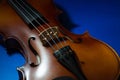 Side Lit Violin Body on a Blue Surface