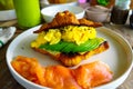 A side look of healthy food - croissant with scramble eggs, sliced avocado, smoked salmons.