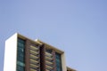 Side low angle view of the front faÃÂ§ade of a yellowish high-rise building. Royalty Free Stock Photo