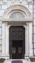 Side marble portal of the Duomo in Carrara Italy